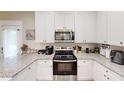 Modern kitchen featuring white cabinets, granite countertops, and stainless steel appliances at 40 Luther Knight Se Rd, Cartersville, GA 30121