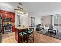 Open concept kitchen featuring a breakfast bar, wood cabinets, stainless steel appliances, and ample counter space at 1421 Peachtree Ne St # 211, Atlanta, GA 30309