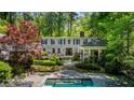 Beautiful backyard featuring a pool, patio, and lush landscaping for outdoor enjoyment at 2890 Howell Mill Rd, Atlanta, GA 30327