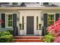 Elegant front entrance with decorative molding, black shutters, and a brick walkway at 2890 Howell Mill Rd, Atlanta, GA 30327