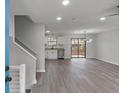 Open concept living space boasts sleek flooring, modern lighting and sliding glass doors to the backyard at 3840 Natalie Way, Ellenwood, GA 30294