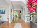 Bright foyer featuring hardwood floors, gray walls, and a view into the living area at 690 Sienna Dr, Cumming, GA 30040
