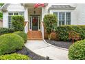 Inviting front entrance with brick steps, manicured bushes, and walkway at 690 Sienna Dr, Cumming, GA 30040