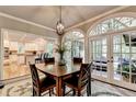 Bright dining room with dark wood table and seating area and connecting views of a modern kitchen at 1595 Northcliff Trce, Roswell, GA 30076