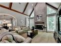 Spacious living room boasting a fireplace with brick surround, high ceilings, and neutral decor at 1595 Northcliff Trce, Roswell, GA 30076