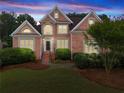 Beautiful brick two-story home with manicured lawn and mature landscaping at 1721 Mulberry Lake Dr, Dacula, GA 30019