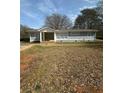 Single story home featuring neutral gray tones and a well maintained yard at 2041 Olive Springs Rd, Marietta, GA 30060