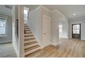 Open foyer featuring wood-look floors, staircase, and a view into the adjacent living spaces at 4032 Andover Cir, Mcdonough, GA 30252