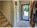 Bright foyer with carpeted stairs and views to the front yard at 265 Oak Hill Dr, Covington, GA 30016