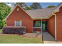 Inviting brick home with a covered front porch and landscaped garden bed at 265 Oak Hill Dr, Covington, GA 30016