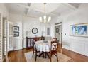 Elegant dining room features hardwood floors, decorative molding, and a stylish chandelier at 3687 Canyon Ridge Ne Ct, Brookhaven, GA 30319