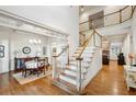 Bright foyer with hardwood floors, staircase, and an open view of the dining and living areas at 3687 Canyon Ridge Ne Ct, Brookhaven, GA 30319