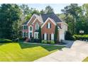 Charming two-story brick home with driveway, basketball hoop and beautifully landscaped front yard at 3705 Rolling Creek Dr, Buford, GA 30519