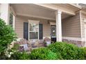 Cozy front porch with comfortable seating, offering a relaxing spot to enjoy the well-maintained landscaping at 4271 Haywater Cv, Buford, GA 30519