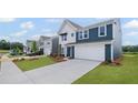 Charming two-story home with a two car garage and manicured lawn at 107 Cherry Glen Way, Euharlee, GA 30145