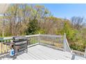 Outdoor deck area perfect for grilling with a serene wooded view at 224 Prominent Loop, Mcdonough, GA 30253