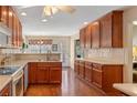 Well-lit kitchen with wood floors, ample counter space, and abundant natural light at 224 Prominent Loop, Mcdonough, GA 30253