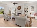 Cozy living room with a fireplace, built-in shelving, and large windows providing natural light at 5247 Flannery Chase Sw, Powder Springs, GA 30127