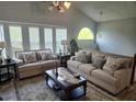 Bright living room with vaulted ceilings, large windows, and comfortable seating arrangement at 5602 Ardmore Ct, Sugar Hill, GA 30518