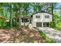 Inviting home with brick accents, mature trees and an attached two-car garage at 671 Shannon Green Sw Cir, Mableton, GA 30126