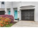 Townhome exterior with a bright blue door, black garage and lovely flower bed at 951 Glenwood Se Ave # 1805, Atlanta, GA 30316