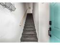 Interior staircase featuring neutral walls, black treads and a wooden handrail at 951 Glenwood Se Ave # 1805, Atlanta, GA 30316