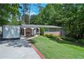 Charming brick home with manicured lawn, lush landscaping, and covered carport in a desirable neighborhood at 3533 Keswick Dr, Atlanta, GA 30341
