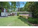 Charming brick home with manicured lawn, lush landscaping, and covered carport in a desirable neighborhood at 3533 Keswick Dr, Atlanta, GA 30341