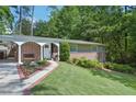 Charming brick home with manicured lawn, lush landscaping, and covered carport in a desirable neighborhood at 3533 Keswick Dr, Atlanta, GA 30341