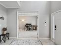 Welcoming foyer with neutral walls and view into adjacent room perfect for an office at 1185 Charter Club Dr, Lawrenceville, GA 30043