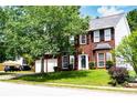 Beautiful brick home featuring a two-car garage and lush green lawn at 1185 Charter Club Dr, Lawrenceville, GA 30043