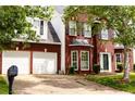 Lovely two-story brick home with an attached two-car garage and a manicured front lawn at 1185 Charter Club Dr, Lawrenceville, GA 30043