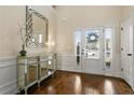 Bright foyer with hardwood floors, stylish mirror, and ample natural light, creating an inviting space at 1307 Clarecastle Ln, Buford, GA 30519