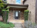 Charming front porch with stone accents and manicured greenery offering a welcoming entrance at 1307 Clarecastle Ln, Buford, GA 30519