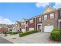 View of several charming brick townhomes with driveways and manicured lawns at 2279 Hawks Bluff Trl, Lawrenceville, GA 30044
