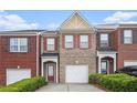 Charming brick townhome with a one-car garage and a well-manicured front yard at 2279 Hawks Bluff Trl, Lawrenceville, GA 30044