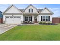 Inviting one-story home with manicured lawn, two-car garage and a cozy front porch perfect for relaxing outdoors at 39 Summer Nw Pl, Cartersville, GA 30121