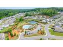Aerial view showcasing community amenities including a pool, tennis courts, playground, and lush landscaping, a desirable neighborhood setting at 6915 Rambling Vale, Cumming, GA 30028