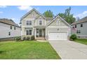 Charming two-story home with a two-car garage, manicured lawn, and stone accents at 6915 Rambling Vale, Cumming, GA 30028