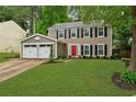 Charming two-story home with a well-manicured front yard and an attached two car garage at 2640 Garland Way, Duluth, GA 30096