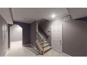 Basement entryway with carpeting, a staircase, neutral paint, and a white door at 4255 Ben Hill Rd, Atlanta, GA 30349