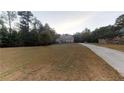 Beautifully landscaped home with a spacious front yard and a long driveway at 4255 Ben Hill Rd, Atlanta, GA 30349