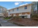 A well-maintained two-story townhouse complex features neutral siding, large windows, and mature landscaping for curb appeal at 6027 Wintergreen Rd, Norcross, GA 30093