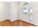 Bright foyer featuring hardwood floors and a decorative glass front door with sidelights at 1934 Mcconnell Rd, Grayson, GA 30017
