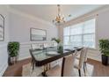 Elegant dining room with a modern glass table and decorative chandelier at 832 Topaz Vly, Canton, GA 30114