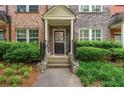 Inviting front porch with stone accents, a covered entry, and lush landscaping at 1227 Ashford Creek Ne Park, Atlanta, GA 30319
