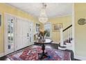 Bright foyer featuring a crystal chandelier, elegant staircase, and beautiful rug at 1241 Briarcliff Ne Rd, Atlanta, GA 30306