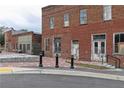 Historic brick building featuring multiple windows and doors, with a paved area in front at 135 Kingsley Way, Acworth, GA 30102
