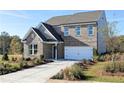Beautiful new construction home with a two-car garage, a brick facade, and landscaped front yard at 135 Kingsley Way, Acworth, GA 30102