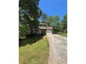Charming two-story home with green siding, stone accents, and a well-maintained front yard at 5250 Mountain Village Ct, Stone Mountain, GA 30083